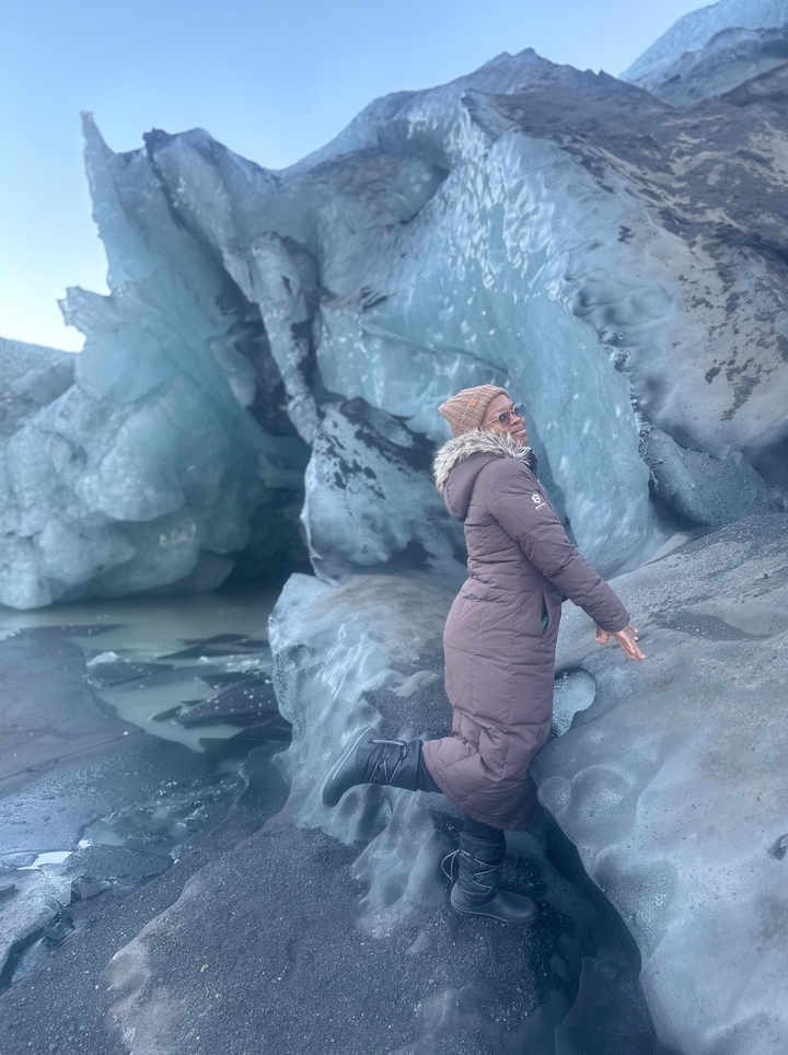 Person standing in front of an ice formation.