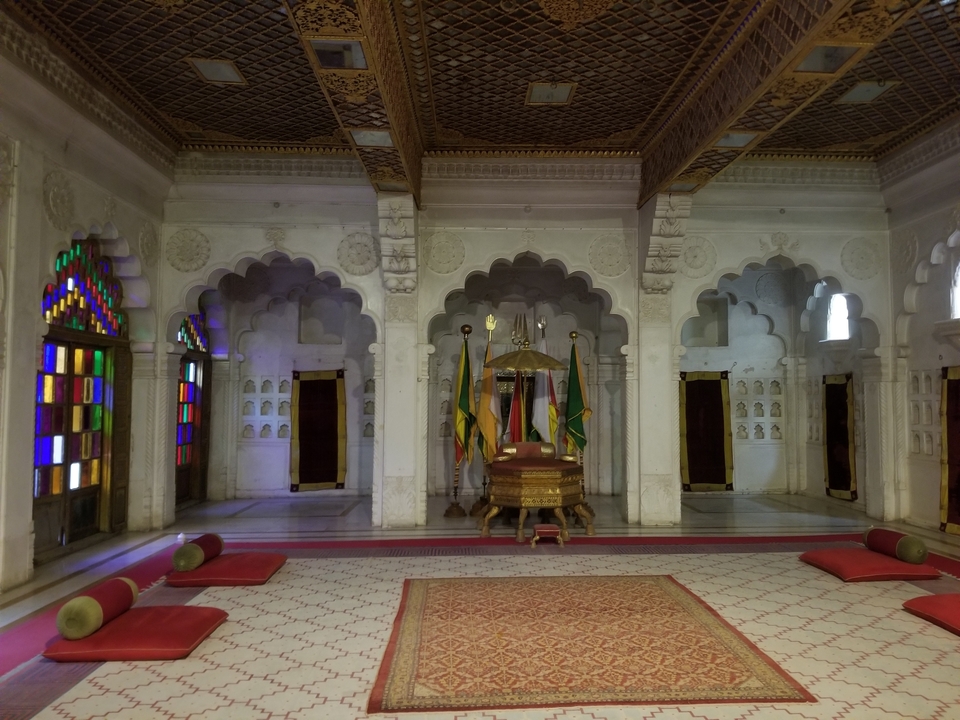 Salle intérieure richement décorée avec des portes voûtées.