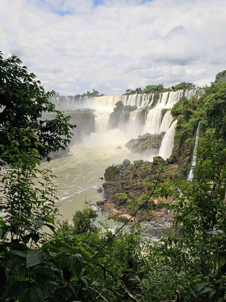View of waterfalls surrounded by lush greenery.