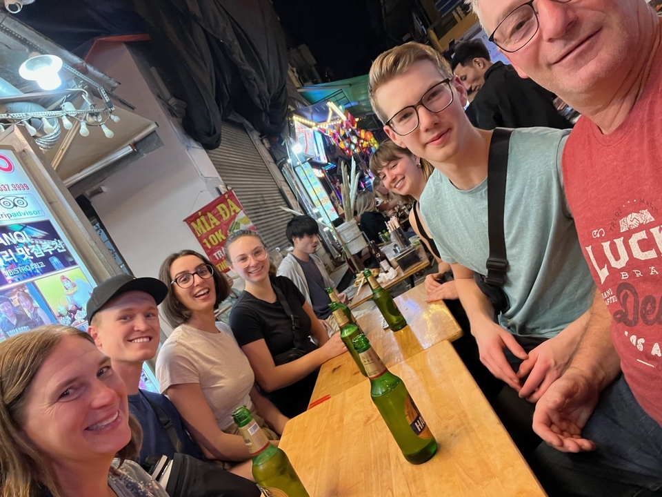 Un groupe de personnes savourant des boissons dans un lieu en bordure de rue.