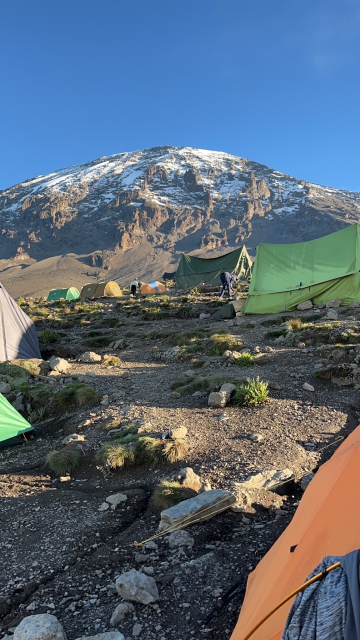 Terrain de camping avec des tentes installées dans une région montagneuse