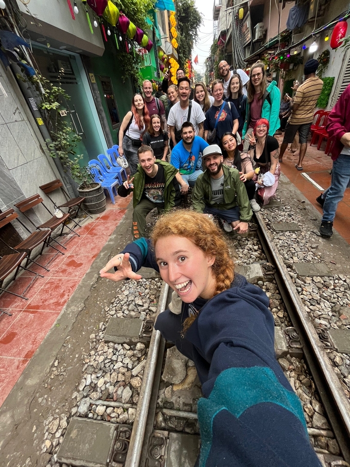 Groupe posant sur des voies ferrées dans une zone urbaine.