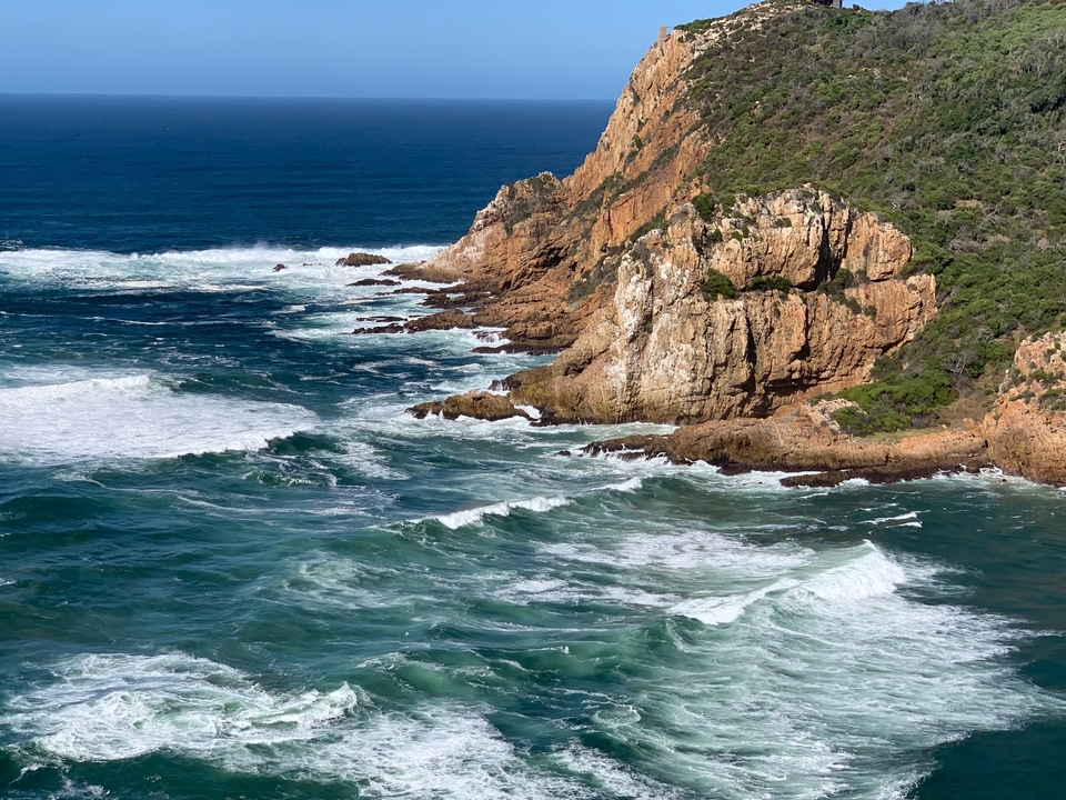Rugged coastline with waves crashing against the rocks.