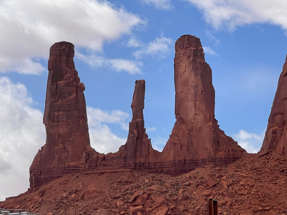 Trois formations rocheuses distinctes contre un ciel bleu.