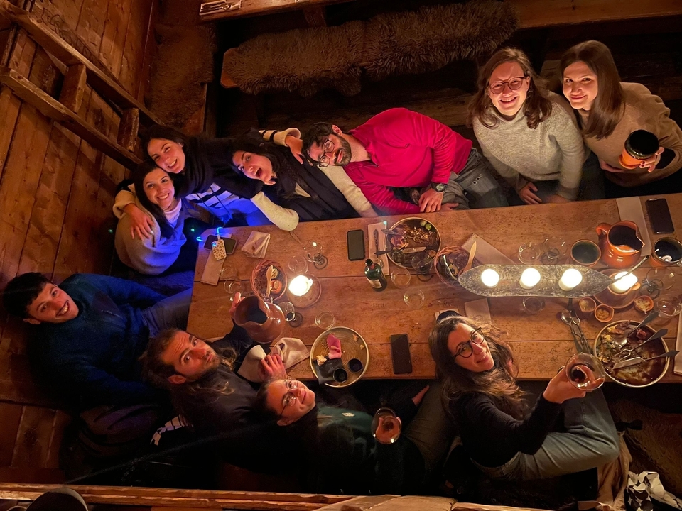 Un groupe qui profite de nourriture et de boissons autour d'une table.