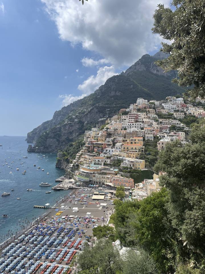 Scenic view of a coastal town with crowded beach