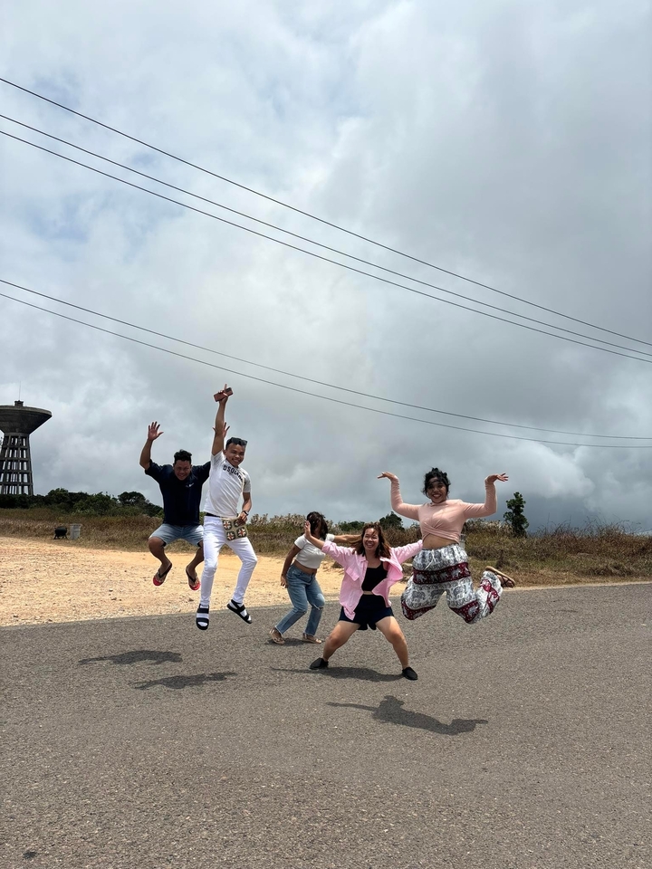 Group jumping in excitement on a roadside.