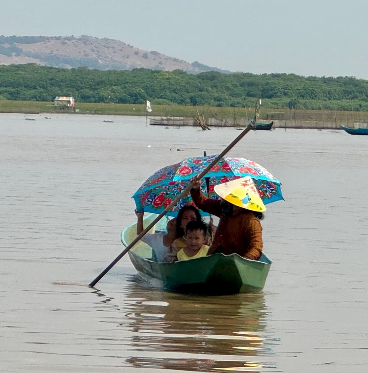 Petit bateau avec famille sur la rivière.