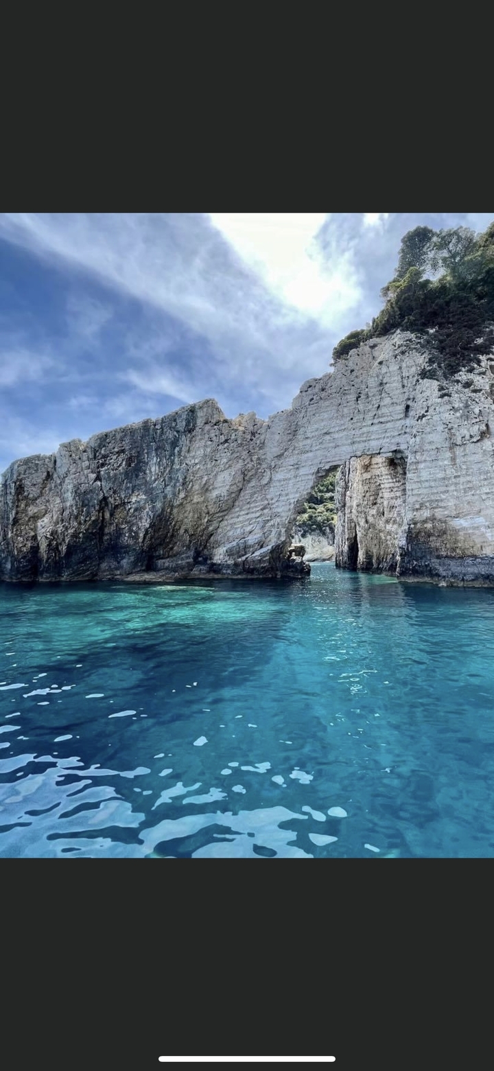 Formation rocheuse côtière avec une arche naturelle au-dessus de la mer.
