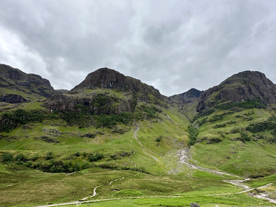 Majestic green hills with cloudy sky.