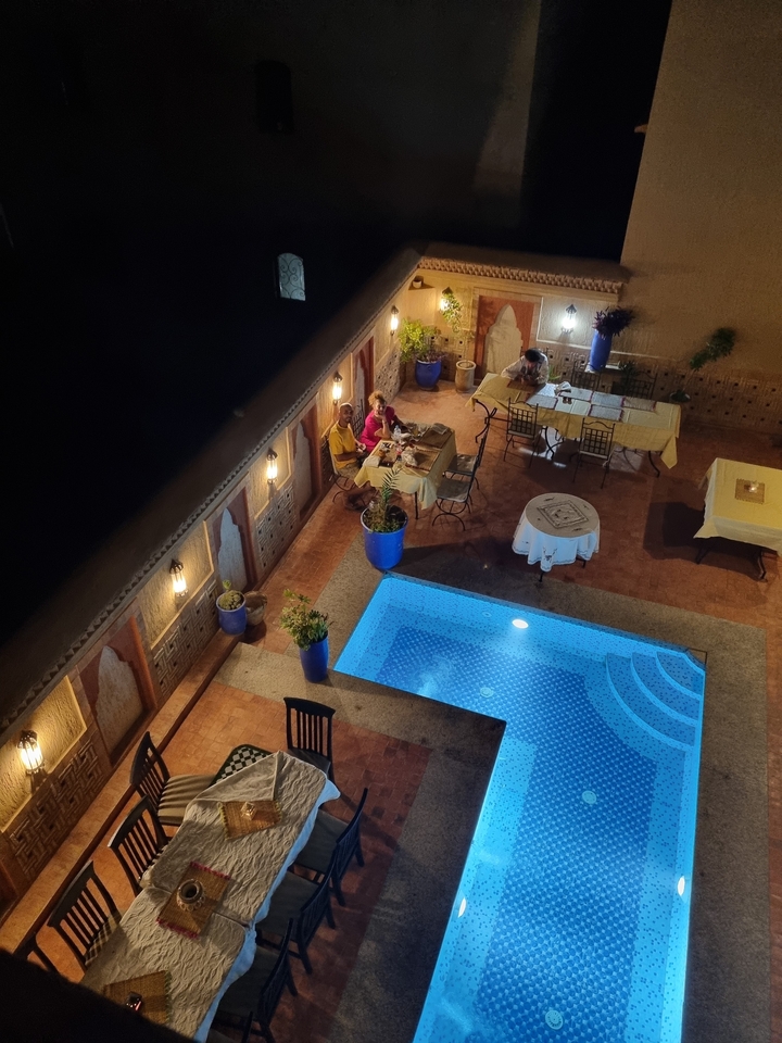 Vue nocturne d'une cour confortable avec une piscine.