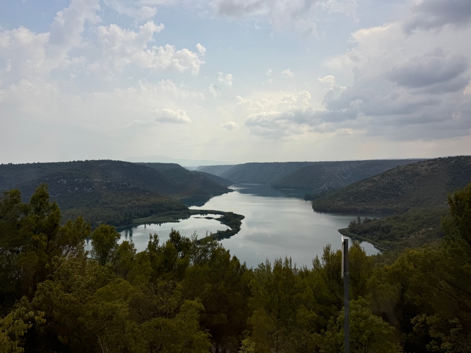 Scenic view of a river surrounded by mountains and forests.