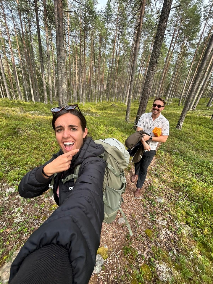 A couple hiking through a forested area.
