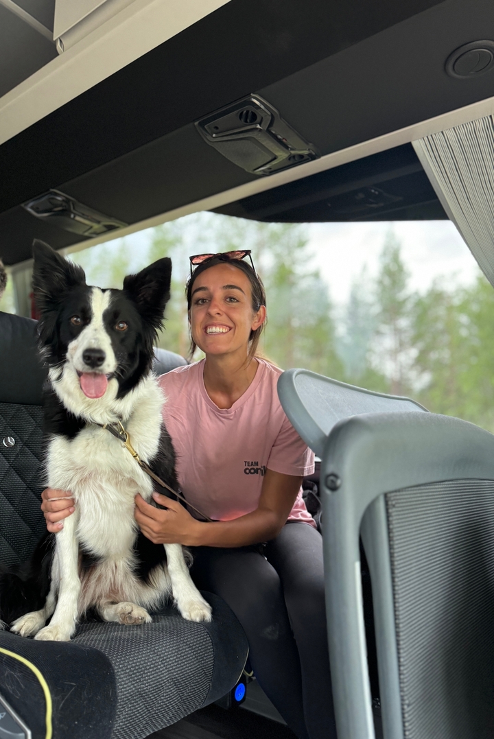 Person with a dog inside a vehicle.