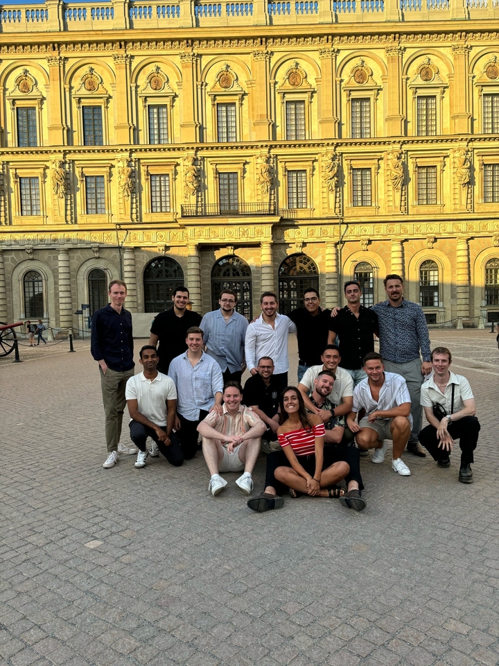 Group photo in front of a historic architectural building.
