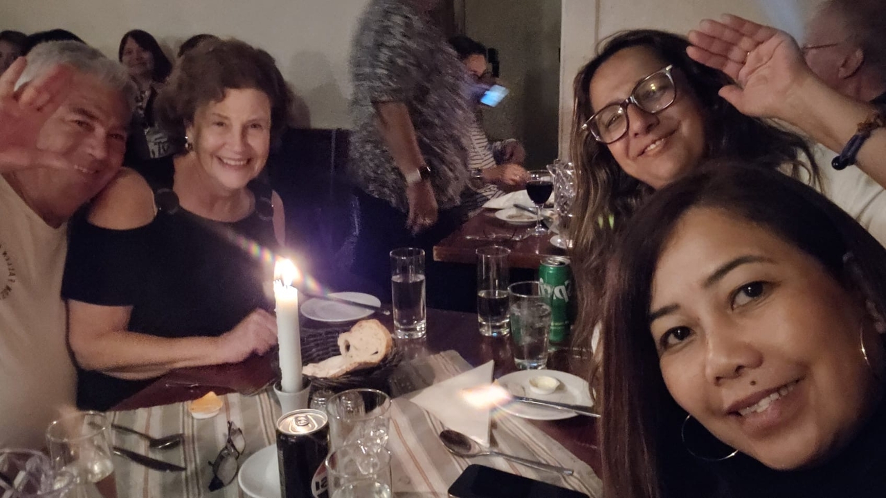 Groupe de personnes assises dans un restaurant faiblement éclairé.