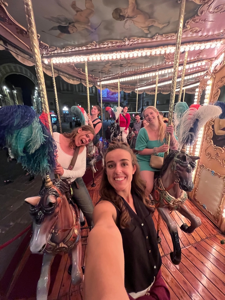 Des gens profitant d'un manège de chevaux de bois la nuit.