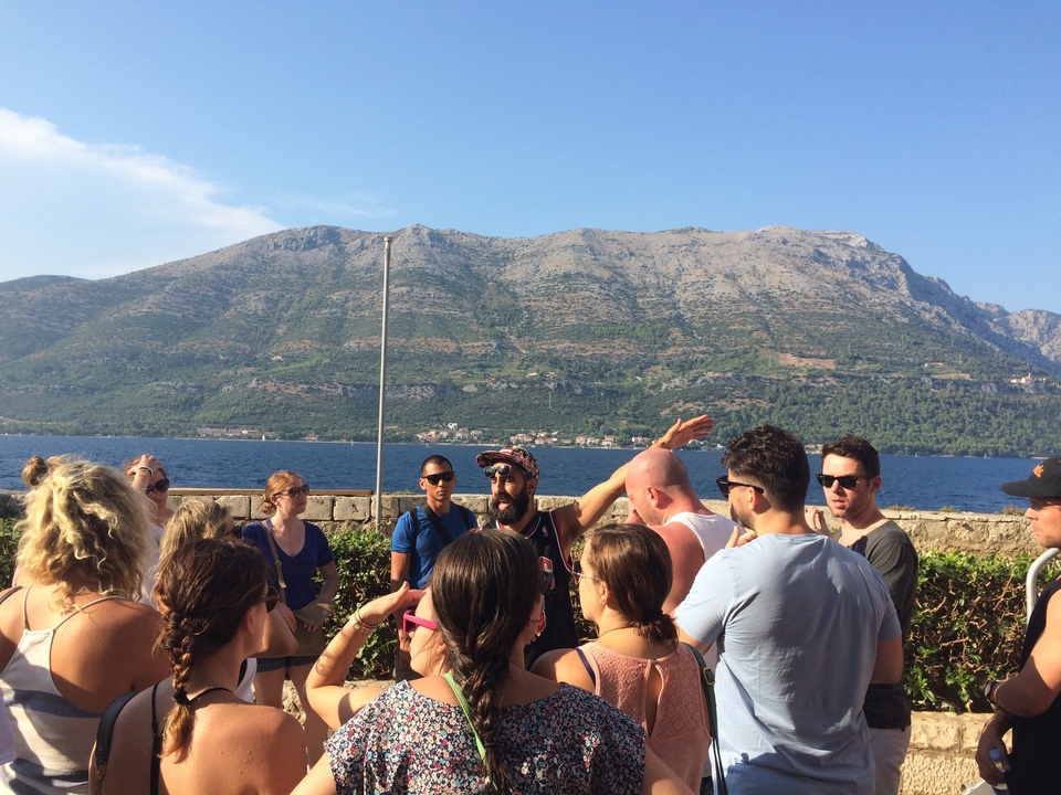 Group of people with a scenic mountain backdrop.