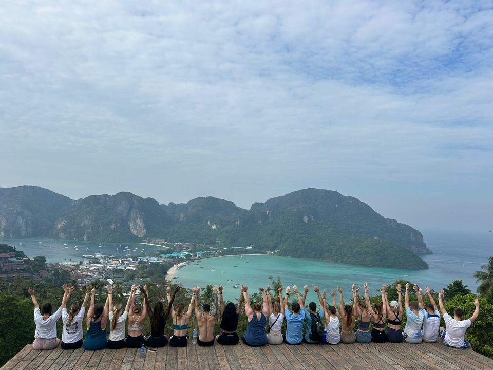 Une vue panoramique d'une baie avec des gens qui lèvent les mains en signe de célébration.