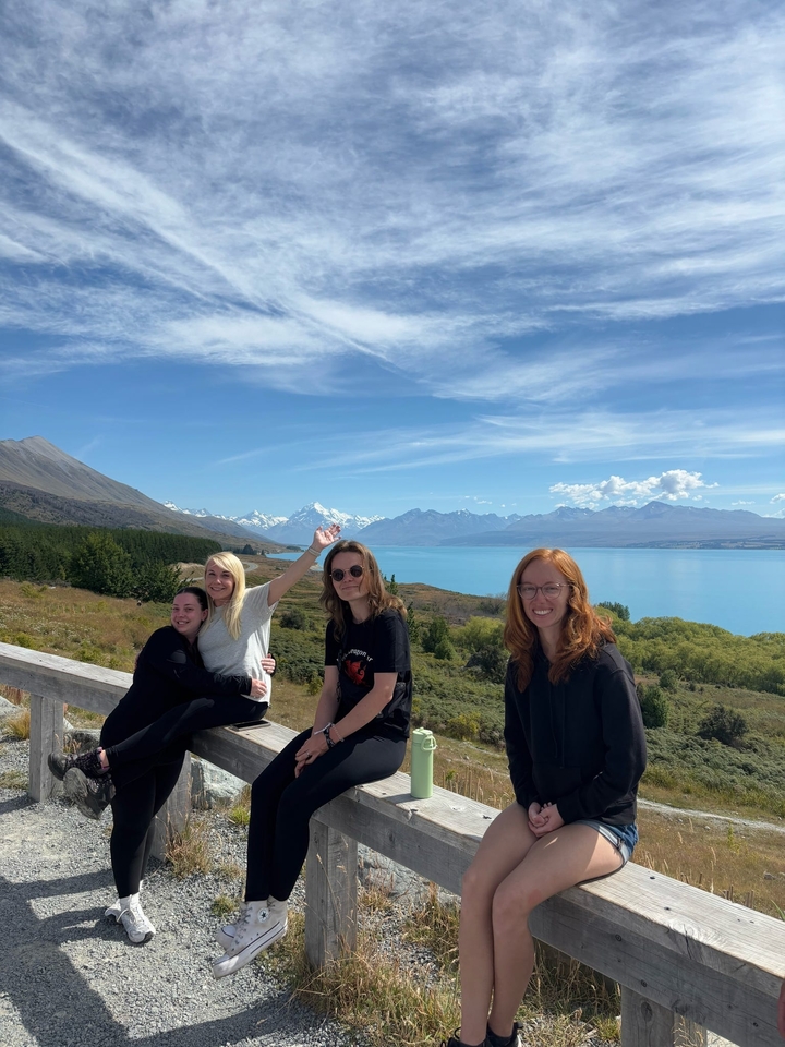 Des gens profitant d'une vue panoramique sur un lac et des montagnes.