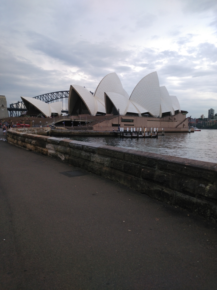 Sydney Opera House and Harbor Bridge view from a walkway.