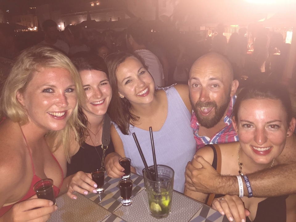 Group of friends enjoying a night out with drinks.