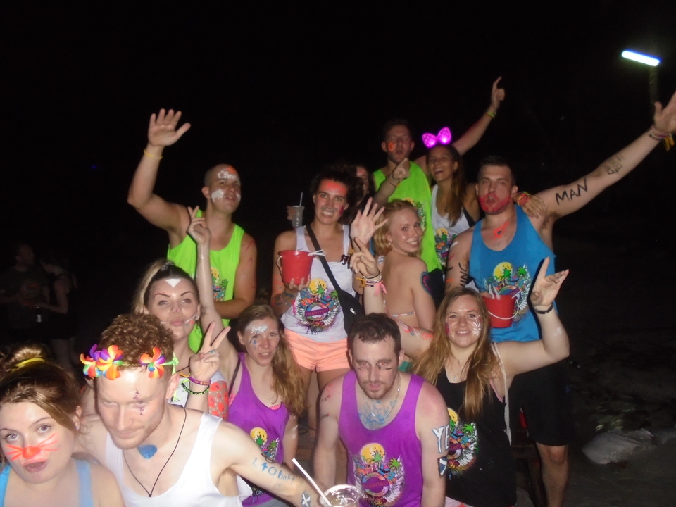 People partying at night with drinks and body paint.