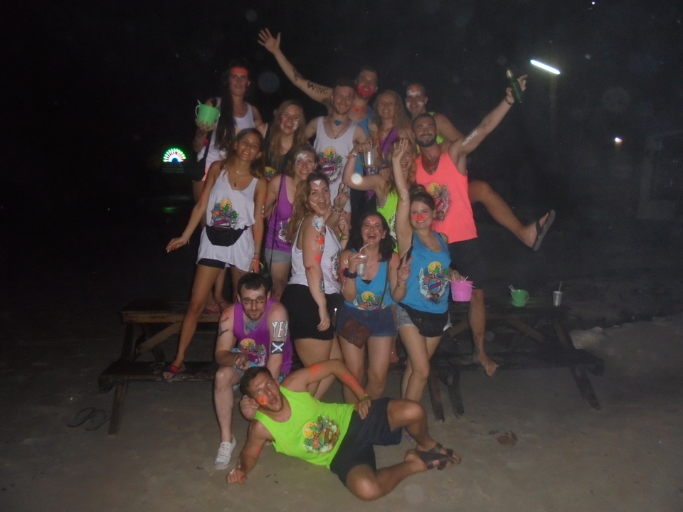 People in colorful attire celebrating at night.