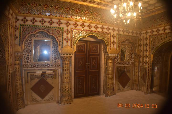 Une pièce ornée de façon complexe avec des miroirs et des motifs colorés.