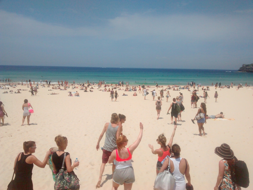 Crowded beach scene with people enjoying the sun.
