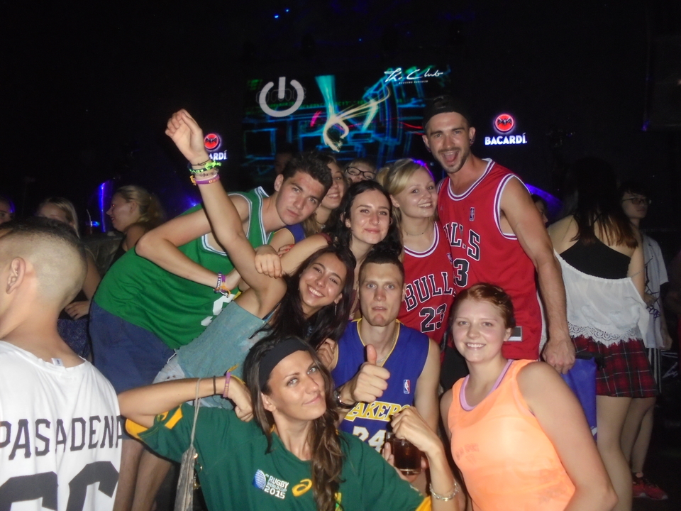 People partying at a club with neon lights.