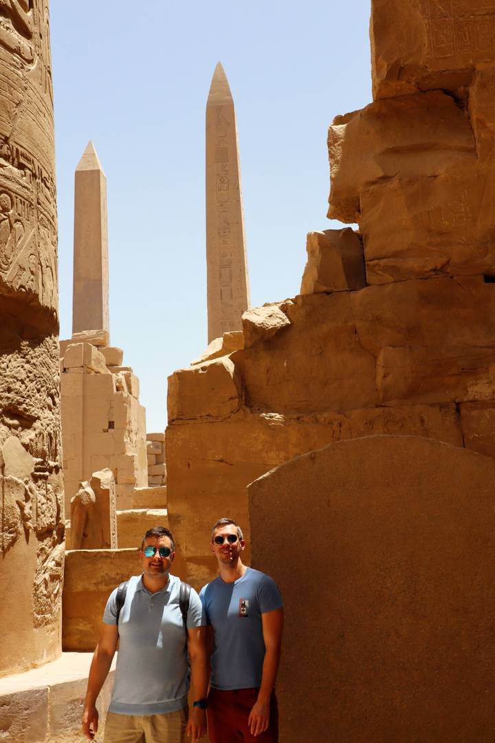 Ancient Egyptian ruins with hieroglyphs and a clear sky.