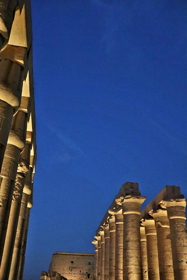 Part of ancient ruins with a deep blue sky.