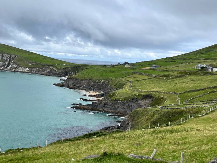 Scenic coastal view of green hills and the ocean.