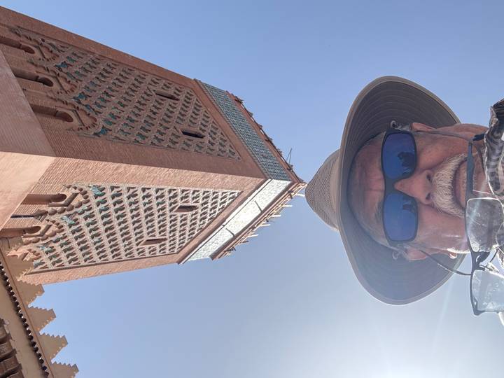 Upside-down image of a man in a hat with a building.