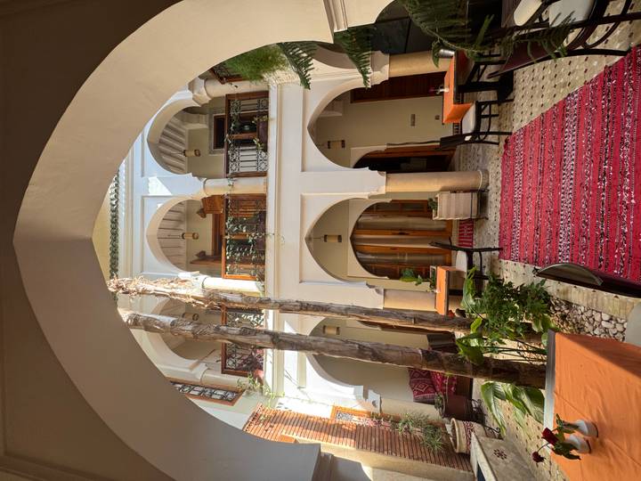 Lovely interior courtyard with arches and decorative carpets.