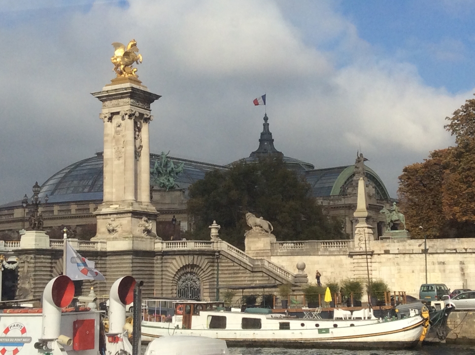 Front view of the Grand Palais in Paris with cloudy skies.
