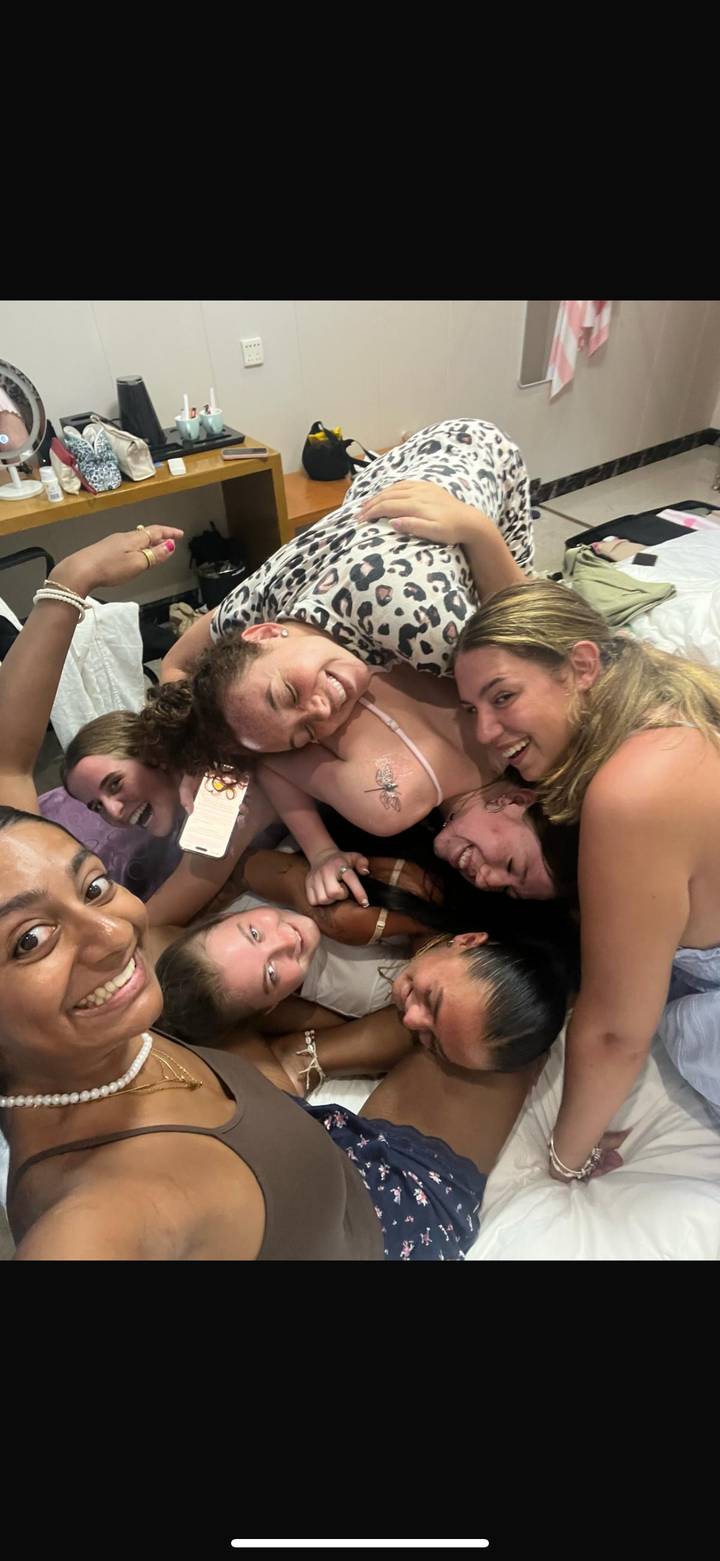Group of friends huddled together in a cozy setting.