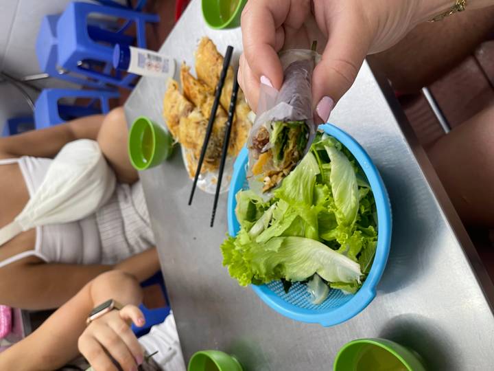 Vietnamese spring rolls with lettuce and a small bowl of dipping sauce.