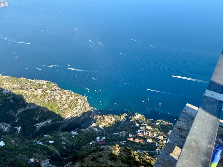 Looking down at boats on the water from a high vantage point.