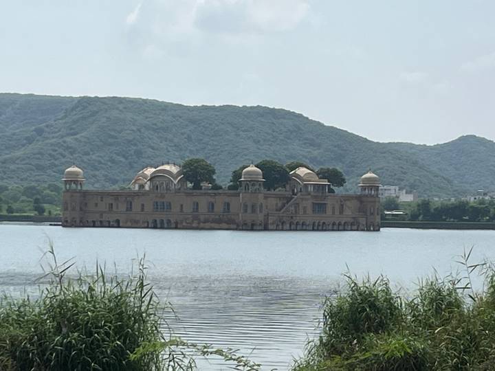 Jal Mahal, gelegen in der Mitte eines Sees mit umgebenden Hügeln.