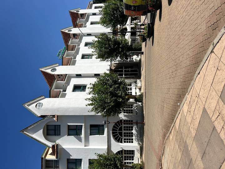 Bâtiment avec des arbres et une grande place en briques, Ifrane.