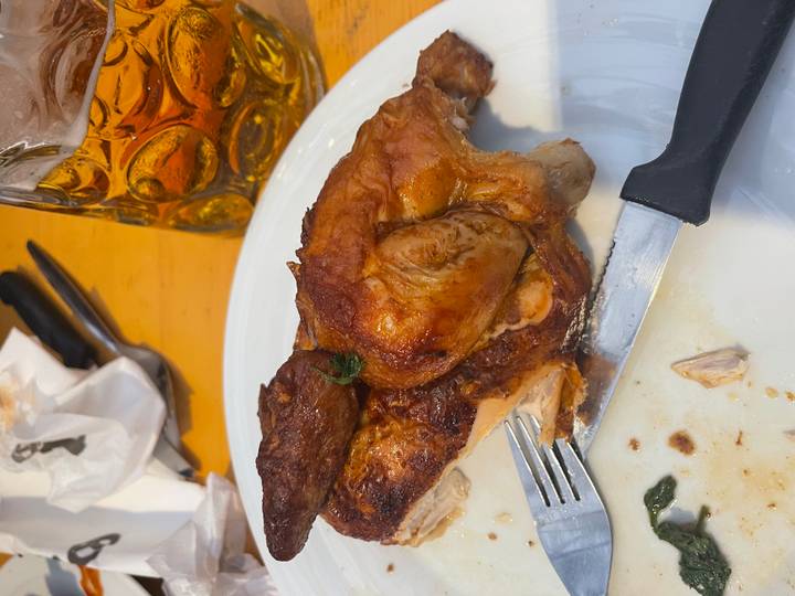 Plate of roasted chicken with a stein of beer.