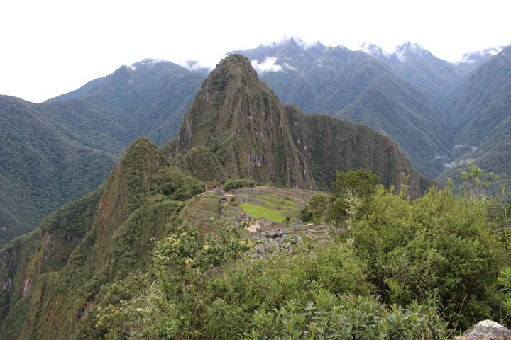 Wide view of Machu Picchu with surrounding mountains