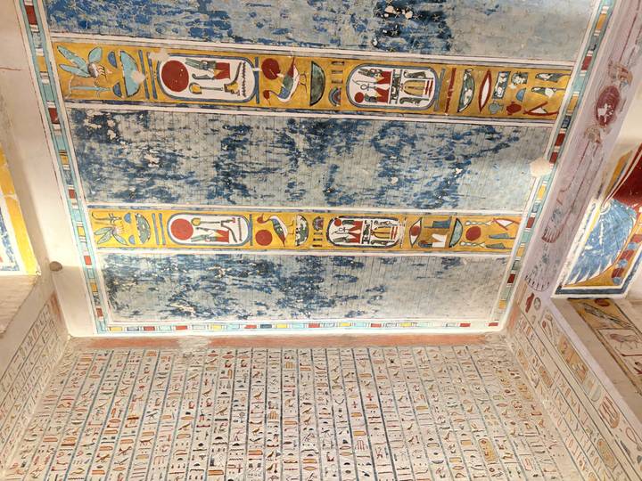 Vibrant wall paintings with Egyptian hieroglyphs and symbols.