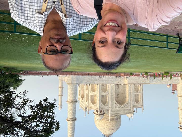 Smiling group with the Taj Mahal in the background.
