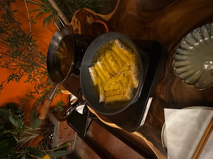Rouleaux de printemps en train de frire dans l'huile sur une cuisinière.