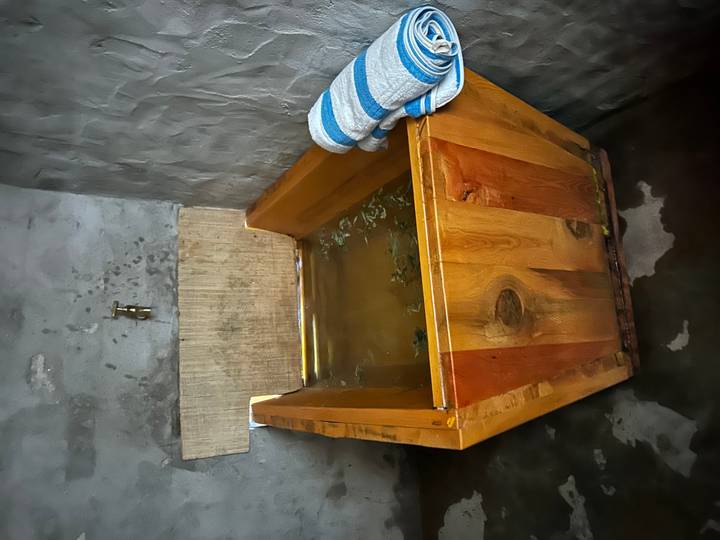 Un bain à remous en bois avec de l'eau et une serviette.