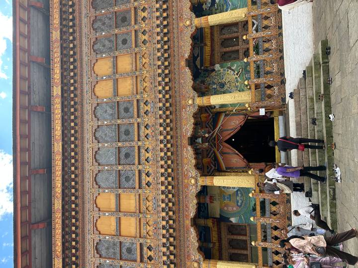 Un temple bouddhiste richement décoré avec des visiteurs.