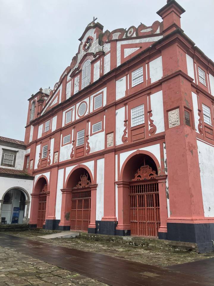 Historic red and white building with decorative elements.